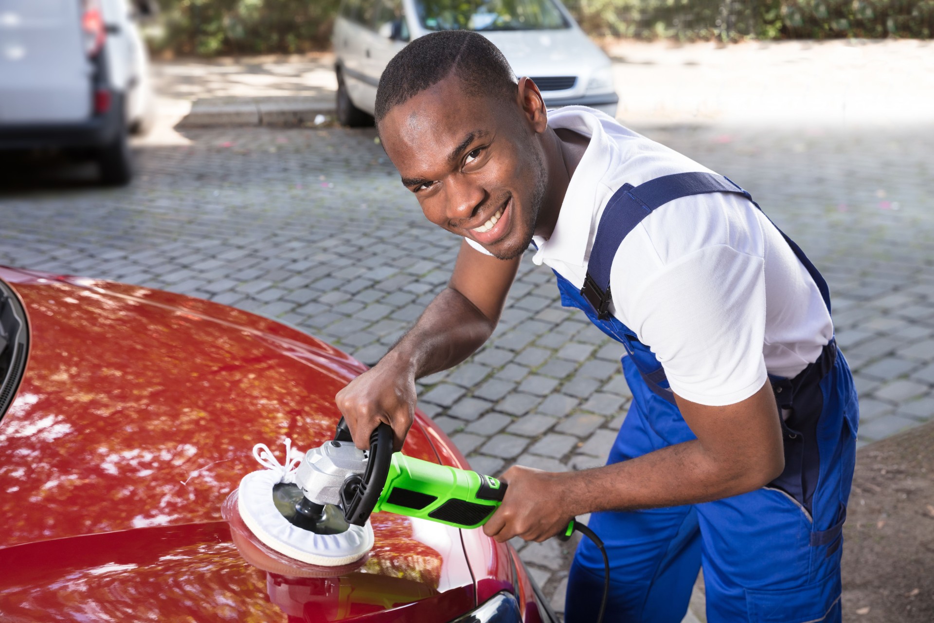 Man Polishing Car With Orbital Polisher