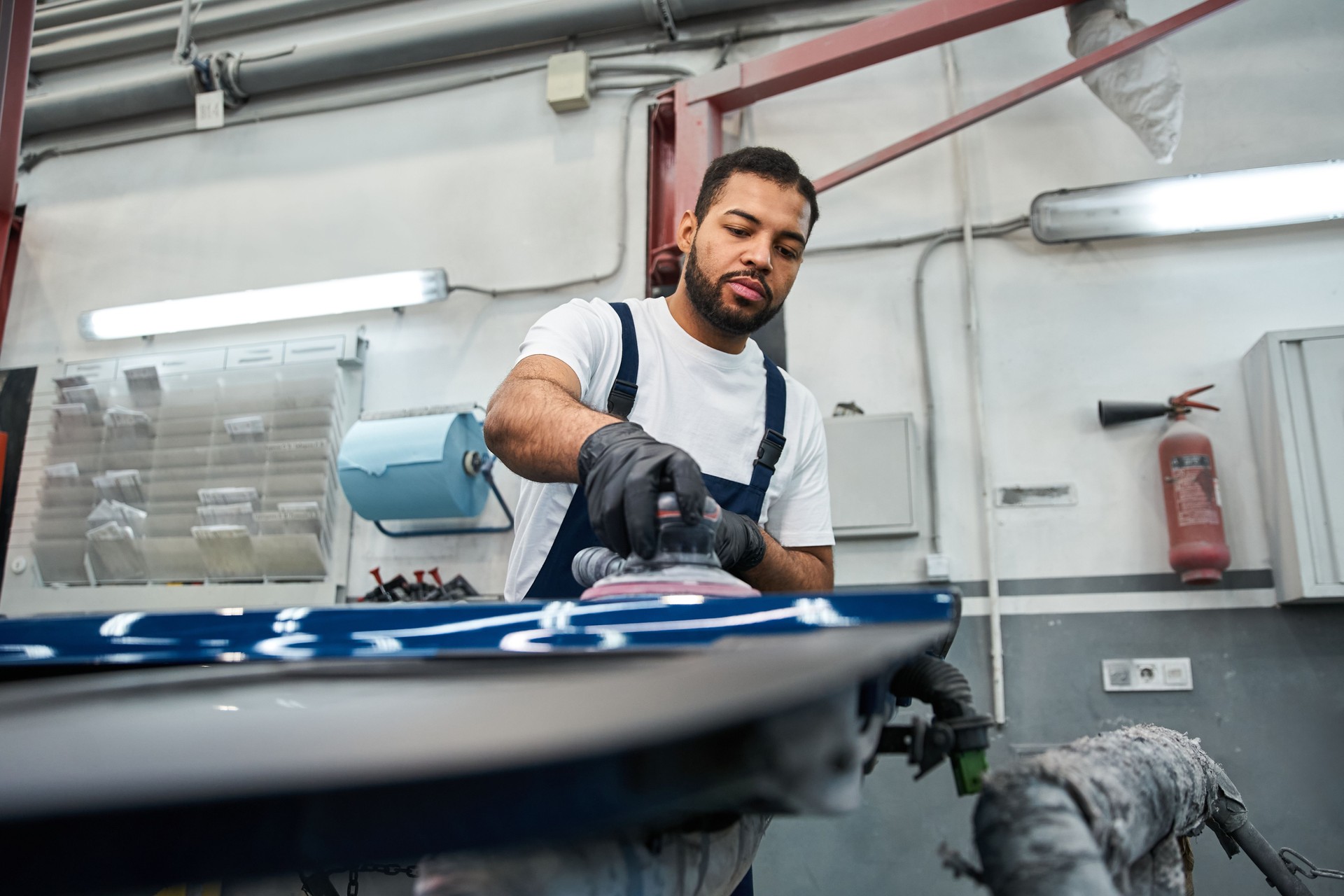Dedicated young mechanic honing skills at a busy auto repair center