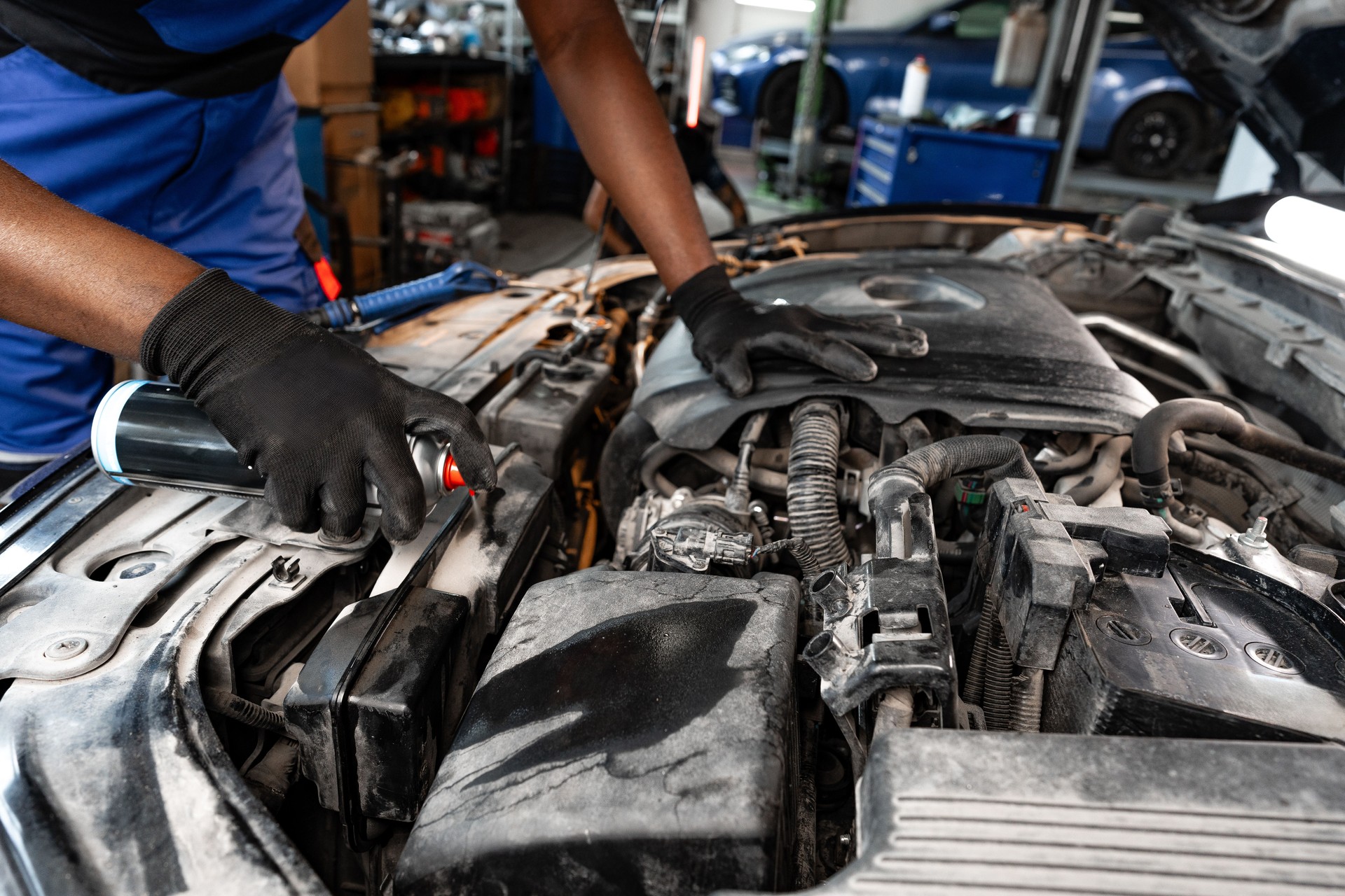 Close up of hands of auto mechanic working in a garage